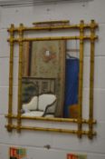 A decorative gilt faux bamboo framed mirror.