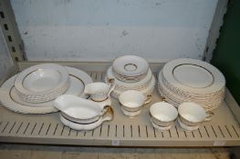 A quantity of gilt decorated white porcelain dinnerware.