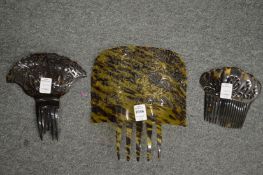 Three pierced and carved tortoiseshell hair combs.