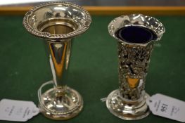 Two silver bud vases.