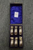 A cased set of six silver napkin rings.