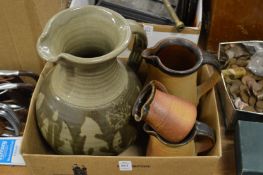 A large pottery jug and a graduated set of three jugs.