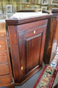 A 19th century oak hanging corner cupboard.