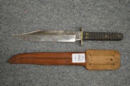 A Wilkinson bowie knife with leather scabbard.