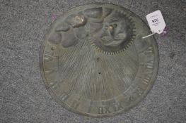 A patinated cast brass circular sun dial.