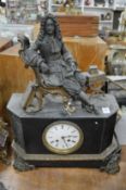 A large slate mantel clock mounted with a seated figure.