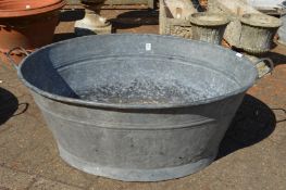 A large galvanised bath tub.