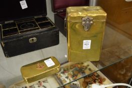 A brass box with steel swing handle together with a naval stuffed box.