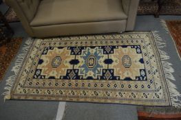 A Persian style rug with geometric decoration 175cm x 110cm.