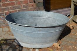 A large galvanised bath tub.