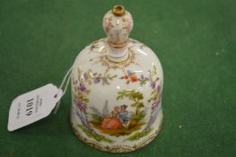 A small porcelain hand bell.