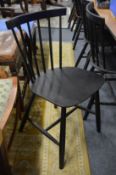 A set of six Danish ebonised stick back dining chairs.