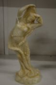 A carved hardstone figure on an Eastern female deity/dancer.