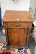A 19th century mahogany washstand with rising top above a cupboard.