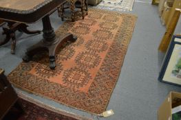 A rust ground Bokhara style rug 220cm x 110cm.