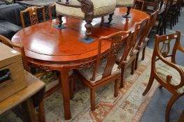 A good Chinese redwood extending table with two leaves together with a set of eight dining chairs,