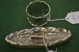 A silver backed nail buffer and silver napkin ring.