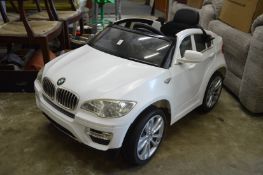 A child’s electrically operated BMW sports car.