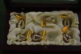 A boxed set of six pear shaped place name holders.