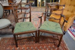 A good set of George III design mahogany dining chairs, two with arms, all with pierced and carved