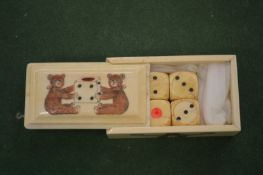 A small bone box containing dice, the cover engraved with two bears.