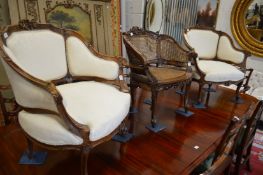 A good pair of French carved walnut and cream upholstered tub armchairs.