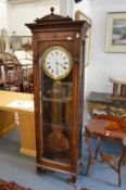 A good French walnut cased floor standing regulator with large brass pendulum.