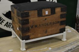 A metal bound pine trunk on stand.