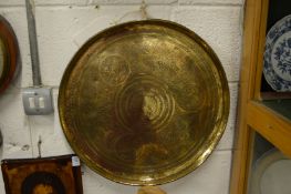 An Eastern engraved brass charger.