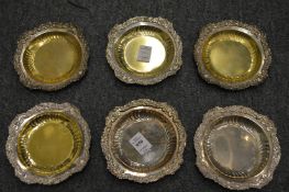 Six silver and sterling silver circular dishes with cast borders.