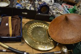 A Chinese wicker hat, large, engraved brass charger and an Eastern dress.