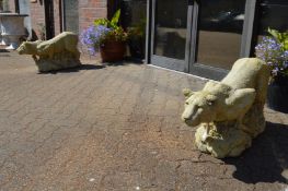 A good large pair of composite garden ornaments modelled as prowling lions on rocky outcrops.