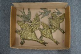 A set of three relief cast brass flying mallards and three smaller swifts.