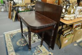 A Regency mahogany extending dining table with patent rachet mechanism, folding top and two extra