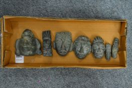 A small group of Mexican carved hardstone faces.