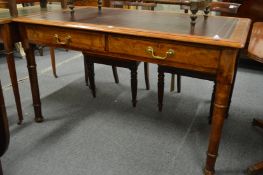 A good Victorian mahogany and leather inset writing table with two drawers on turned supports.