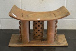 An African carved wood head rest.