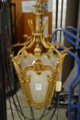 A small ornate brass hall lantern.