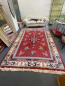 A Chinese red ground carpet 350cm x 250cm.