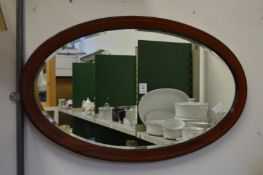 A mahogany oval mirror.