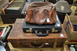 A leather suitcase, a brief case and a leather handbag.
