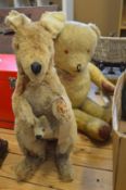 A old stuffed toy of a model a kangaroo and joey and a teddy bear.