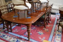 A good 19th century mahogany extending dining table with two leaves on turned and fluted legs with