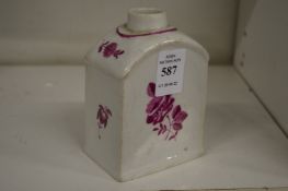 A small puce decorated tea cannister.