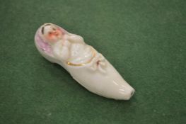 A small porcelain shoe whistle (af).