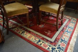 A red ground Chinese carpet 270cm x 170cm.