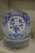 A set of eight small Meissen blue and white plates with pierced borders.