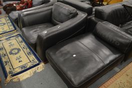 An Incanto black leather large armchair with matching foot stool.