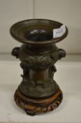 A good small bronze archaic style vase on hardwood stand.