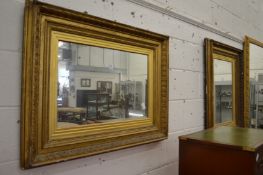 A pair of gilt framed mirrors.